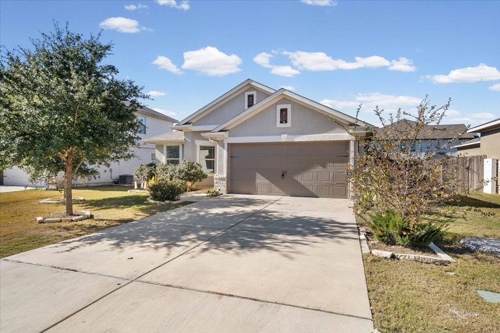 19040 Kimberlite Drive Pflugerville, TX 78660 - Photo 8 of 40 View of front of house with a front yard, driveway, stucco siding, and an attached garage