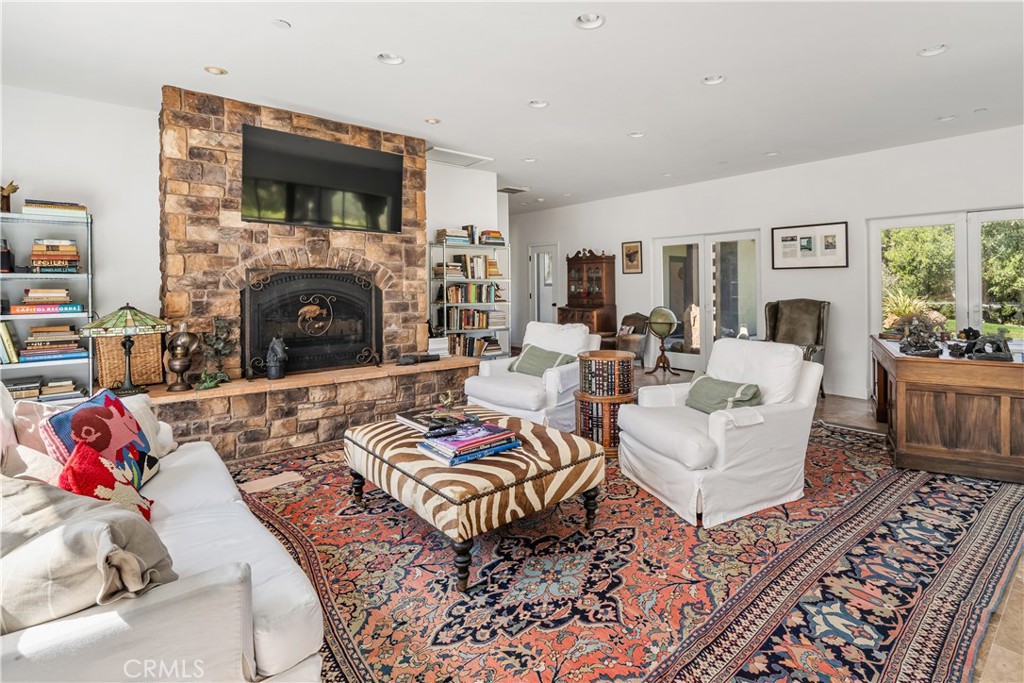8680 Alamo Creek Road Santa Maria, CA 93454 - Photo 19 of 74 a living room with furniture a flat screen tv and a fireplace