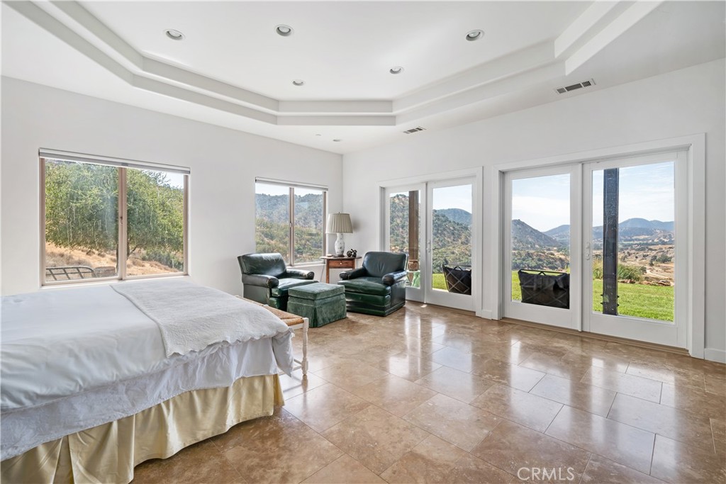 8680 Alamo Creek Road Santa Maria, CA 93454 - Photo 22 of 74 a bedroom with a large bed and a large window with balcony view
