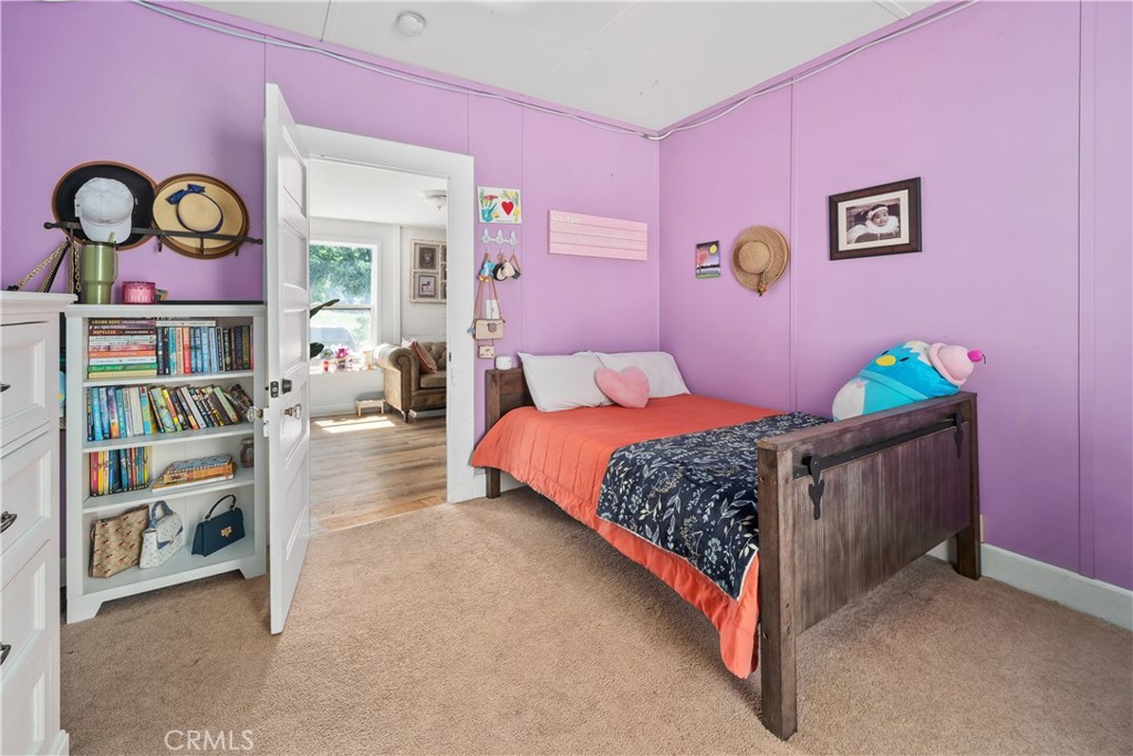 8680 Alamo Creek Road Santa Maria, CA 93454 - Photo 55 of 74 a bedroom with bed and paintings on the wall