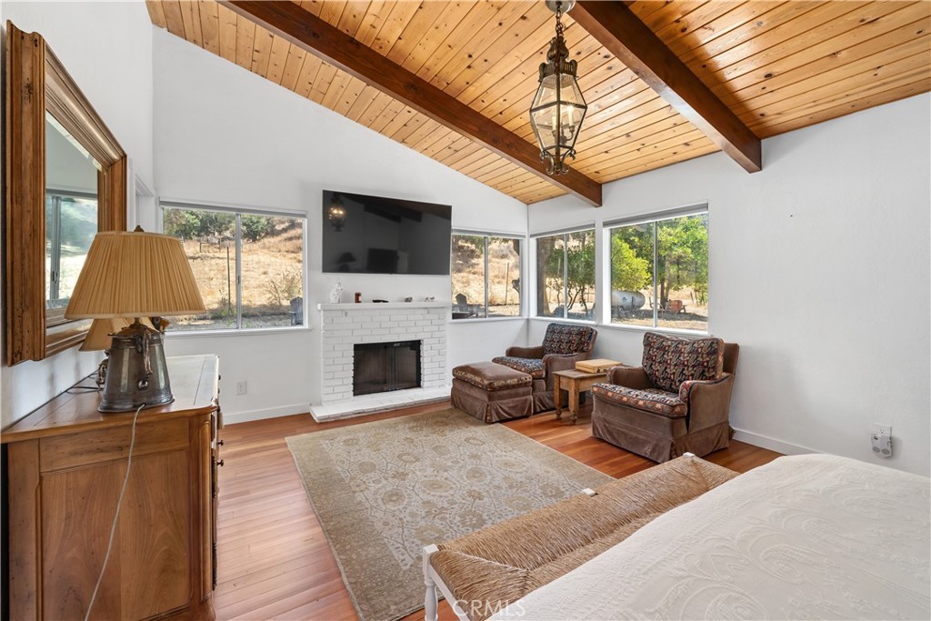 8680 Alamo Creek Road Santa Maria, CA 93454 - Photo 66 of 74 a living room with furniture a fireplace and a flat screen tv