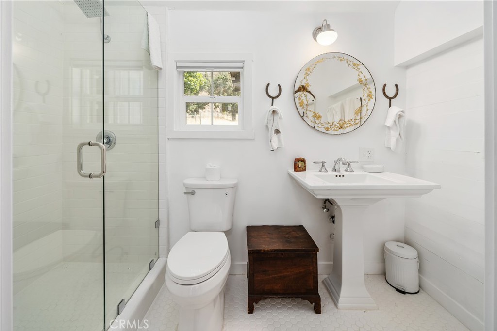 8680 Alamo Creek Road Santa Maria, CA 93454 - Photo 71 of 74 a bathroom with a sink a mirror and a toilet