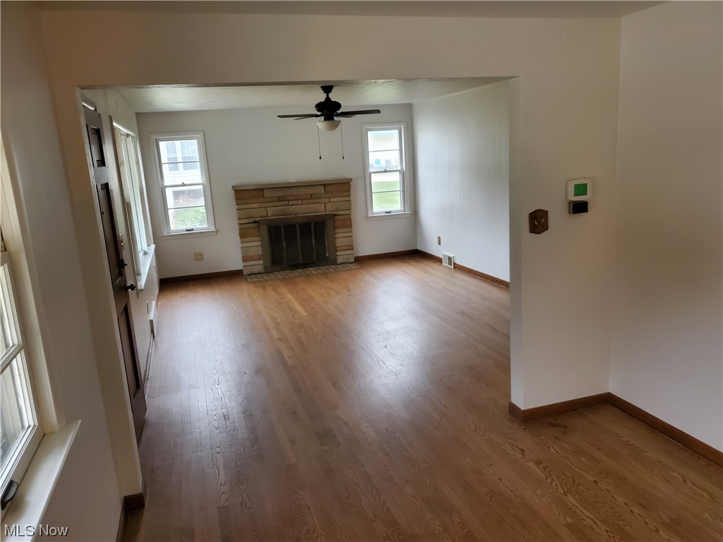 5530 Manchester Road Akron, OH 44319 - Photo 12 of 24 Unfurnished living room featuring a wealth of natural light, ceiling fan, and dark wood-type flooring