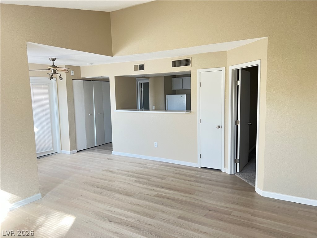 8101 West Flamingo Road, Unit 2161 Las Vegas, NV 89147 - Photo 15 of 15 A well-lit open floorplan space features light wood flooring and a refreshing ceiling fan.