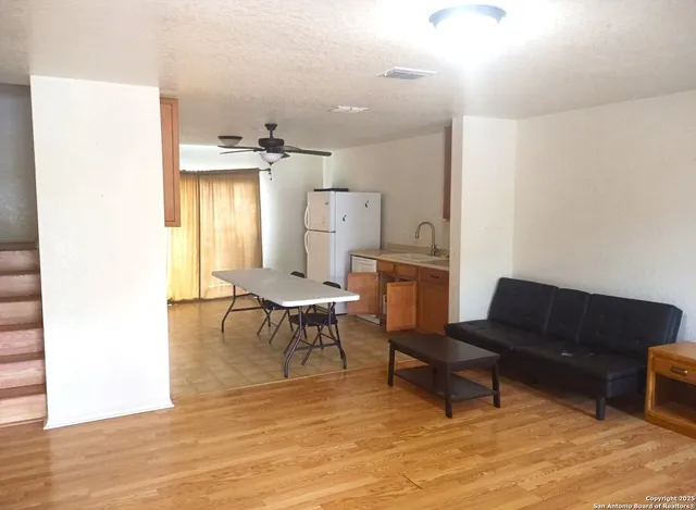 a living room with furniture and a dining table