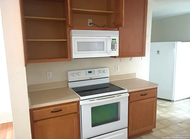 a stove top oven sitting inside of a kitchen