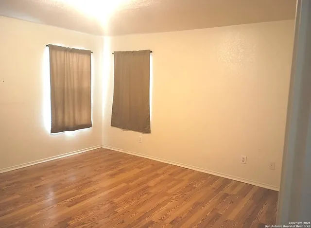 an empty room with wooden floor