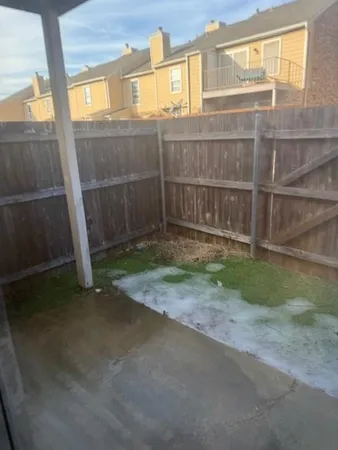 a view of a backyard with fence