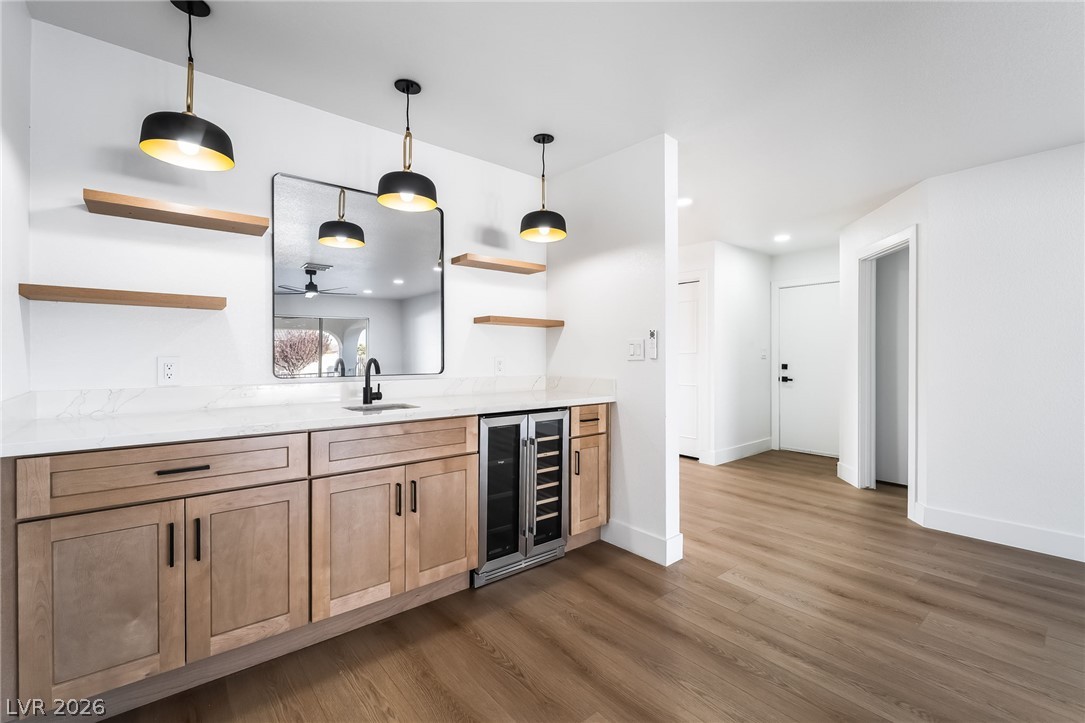 429 Crestway Road Henderson, NV 89015 - Photo 16 of 56 A refined dry bar with modern pendant lighting and built-in wine refrigeration awaits.