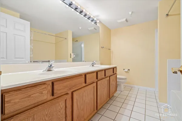 a spacious bathroom with a double vanity sink a mirror and a shower