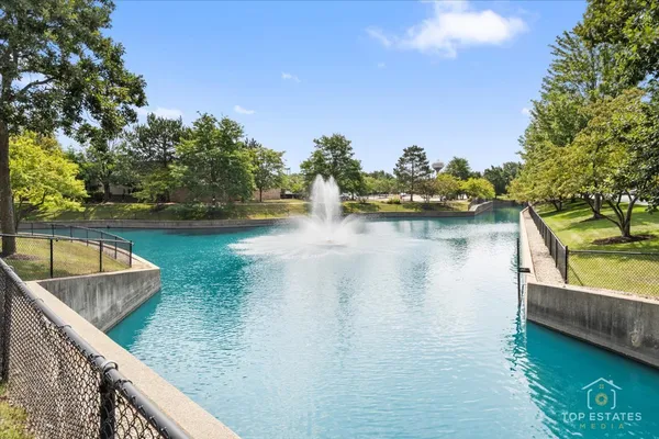 a view of a lake with couches in the patio