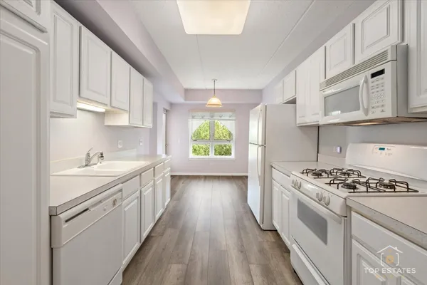 a kitchen with stove cabinets and window