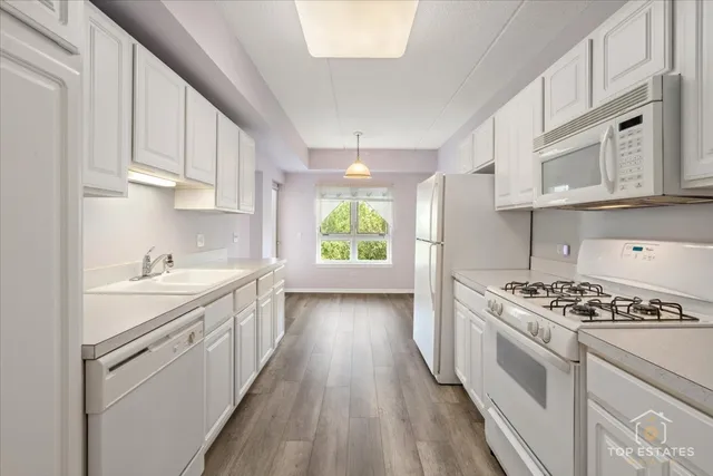 a kitchen with stove cabinets and window