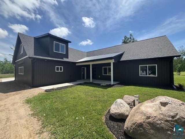 3454 Anderson Road Hibbing, MN 55746 - Photo 1 of 31 Modern farmhouse exterior featuring dark vertical siding and white window trim