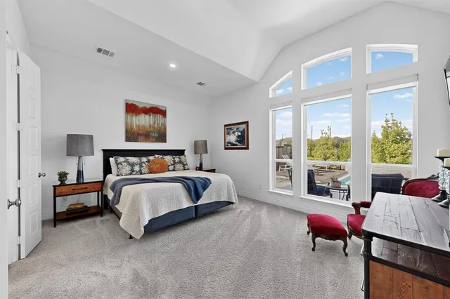 a spacious bedroom with a bed and a couch