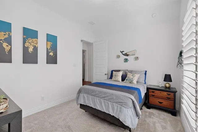 a bedroom with a bed and a couch