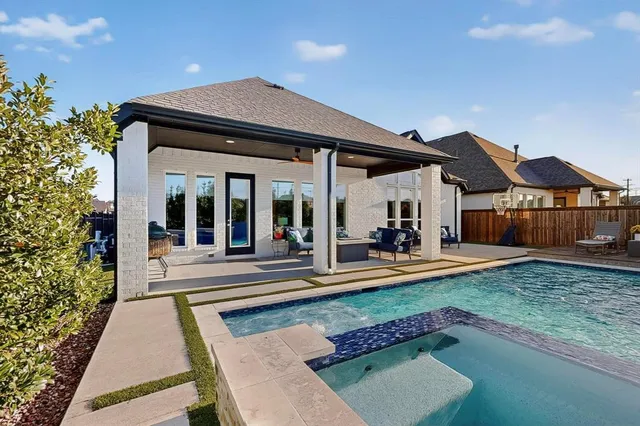 a view of a house with sitting area and swimming pool