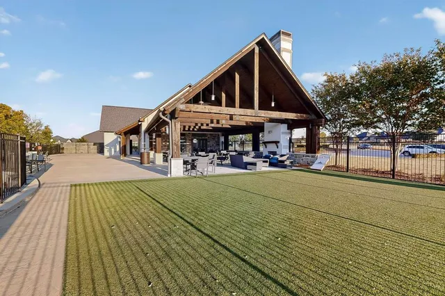 a view of a house with swimming pool and sitting area