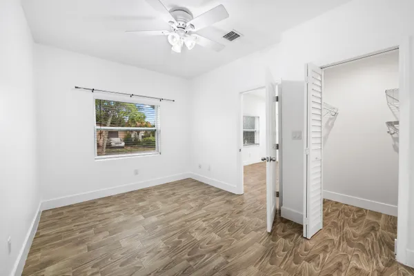 a view of an empty room with a fan