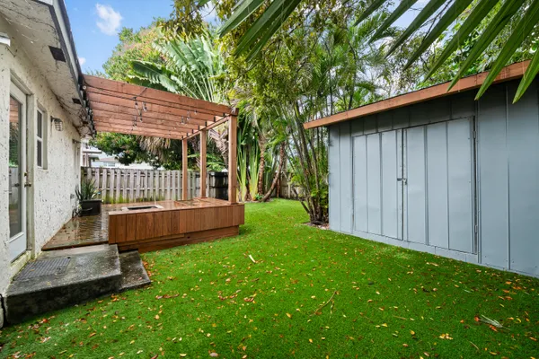 a view of backyard with deck and garden