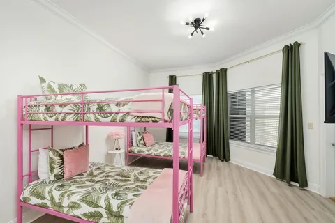 a bedroom with a bed and a chandelier