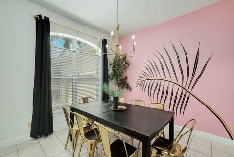 a kitchen with granite countertop kitchen island stainless steel appliances a sink stove refrigerator and wooden floor
