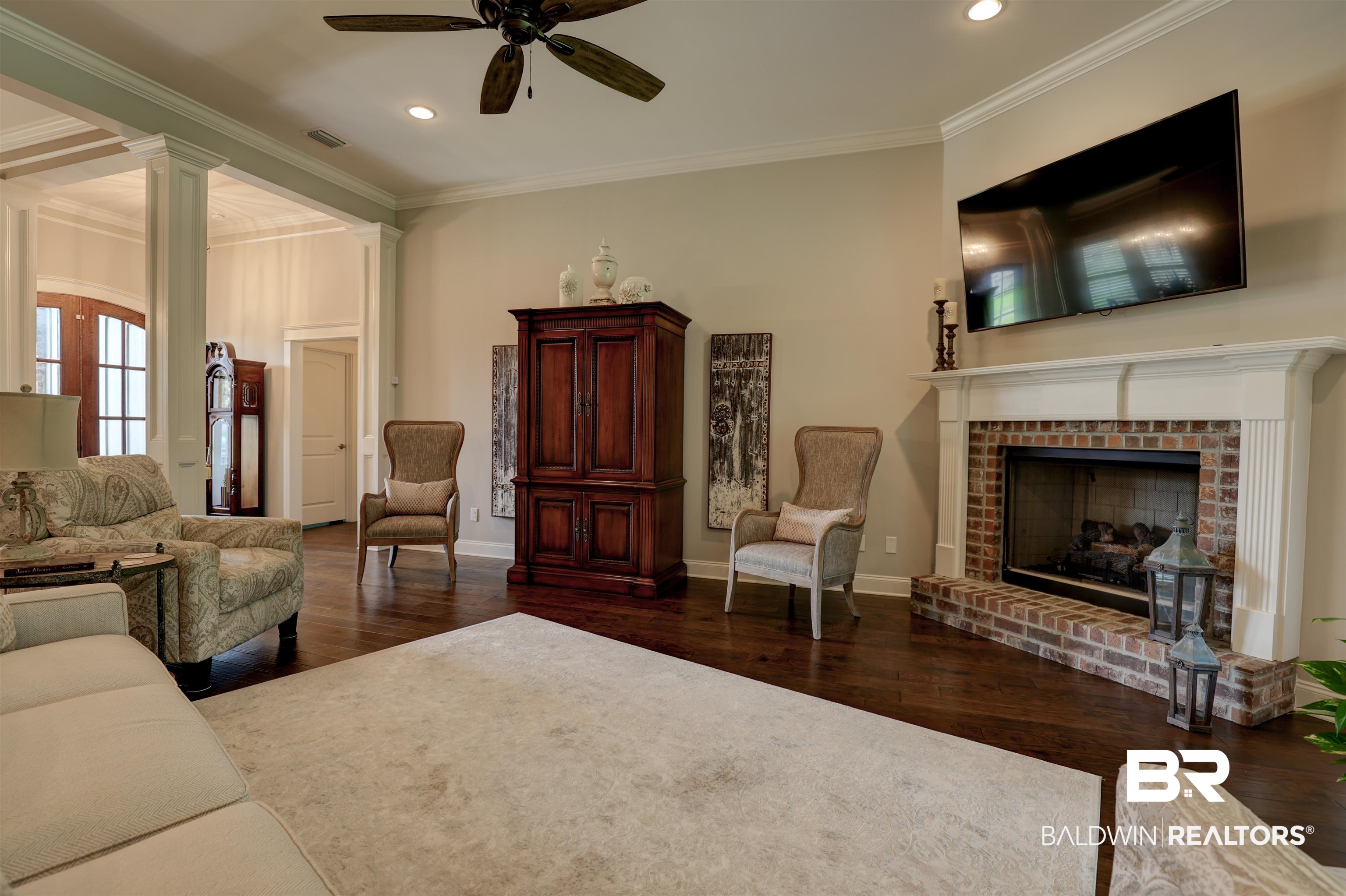 10588 Leesburg Pike Daphne, AL 36526 - Photo 7 of 29 Living room with ceiling fan, dark hardwood / wood-style floors, and crown molding