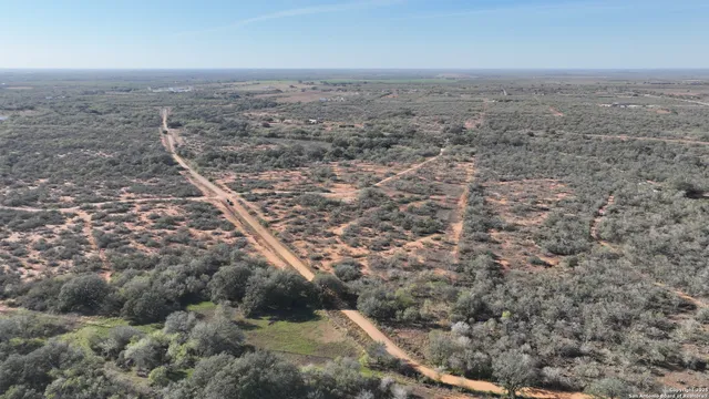 an aerial view of house with yard