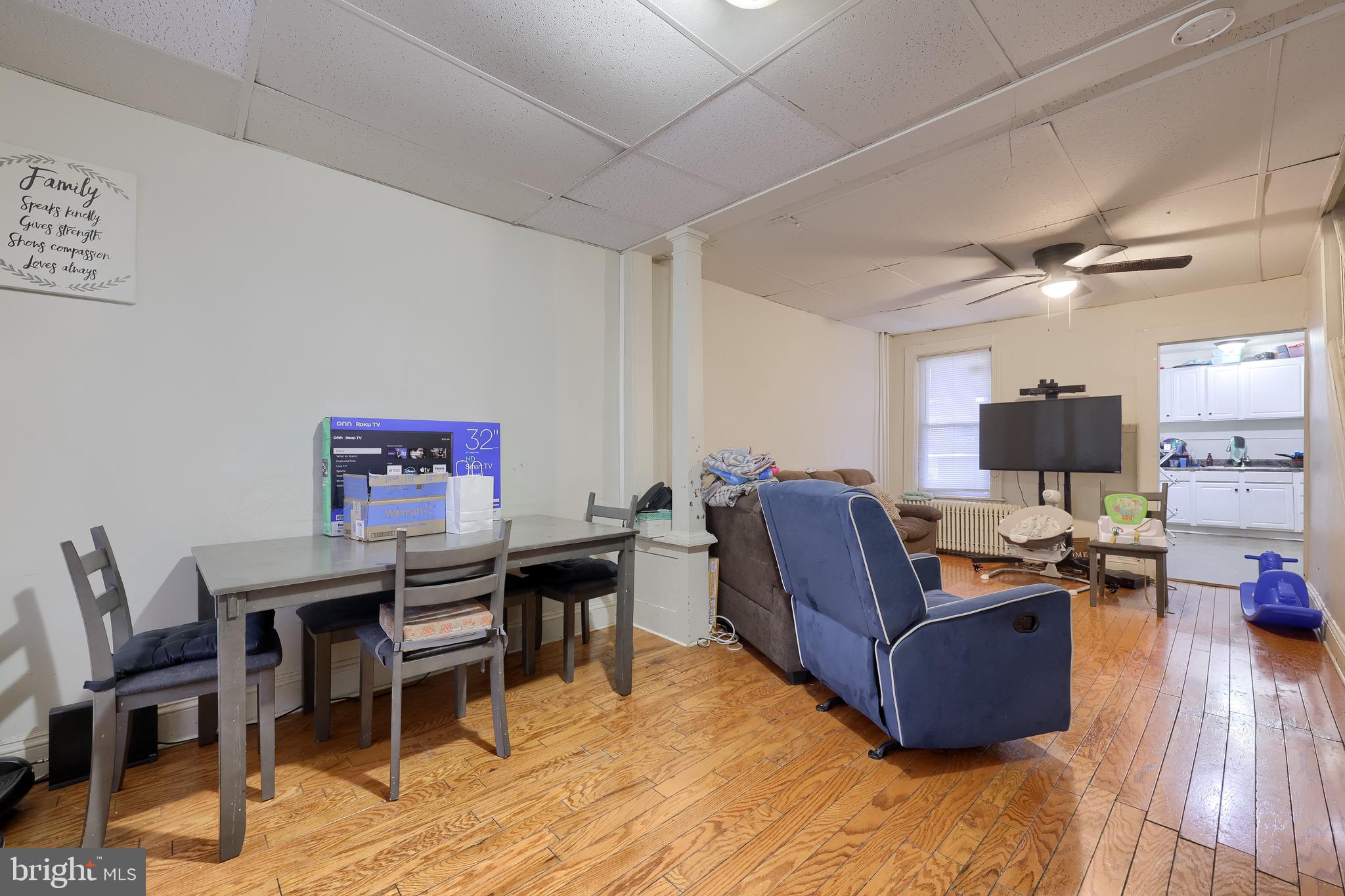 670 Hebrank Street Lancaster, PA 17603 - Photo 4 of 22 a living room with furniture a flat screen tv and kitchen view