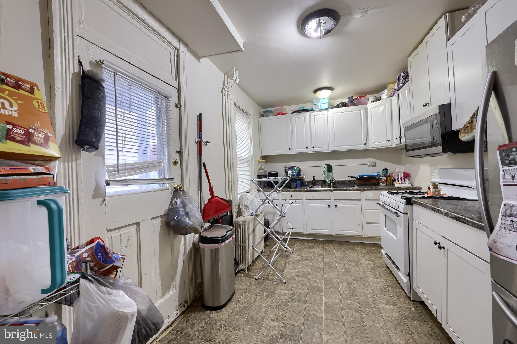 670 Hebrank Street Lancaster, PA 17603 - Photo 8 of 22 a kitchen with stainless steel appliances granite countertop a sink counter space cabinets and a window