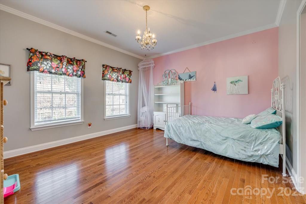 368 Windell Drive Fort Mill, SC 29708 - Photo 28 of 48 a bedroom with a bed chandelier and a window