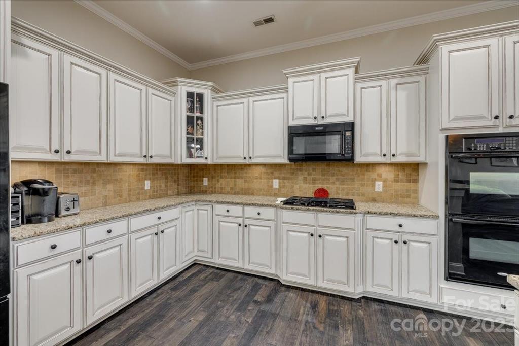 368 Windell Drive Fort Mill, SC 29708 - Photo 8 of 48 a kitchen with granite countertop white cabinets and stainless steel appliances