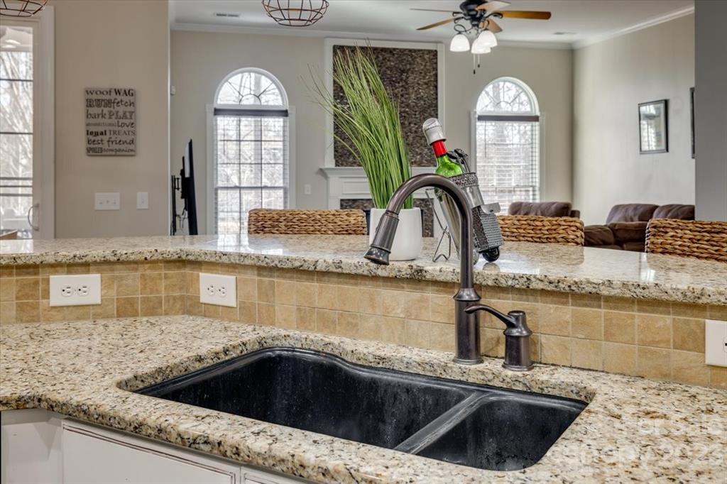 368 Windell Drive Fort Mill, SC 29708 - Photo 10 of 48 a kitchen with a granite countertop sink a stove and a mirror
