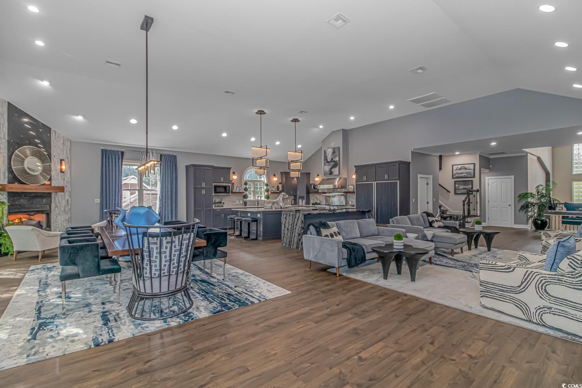 510 Rum Gully Road Murrells Inlet, SC 29576 - Photo 11 of 35 Dining area with vaulted ceiling, wood finished floors, recessed lighting, and a stone fireplace