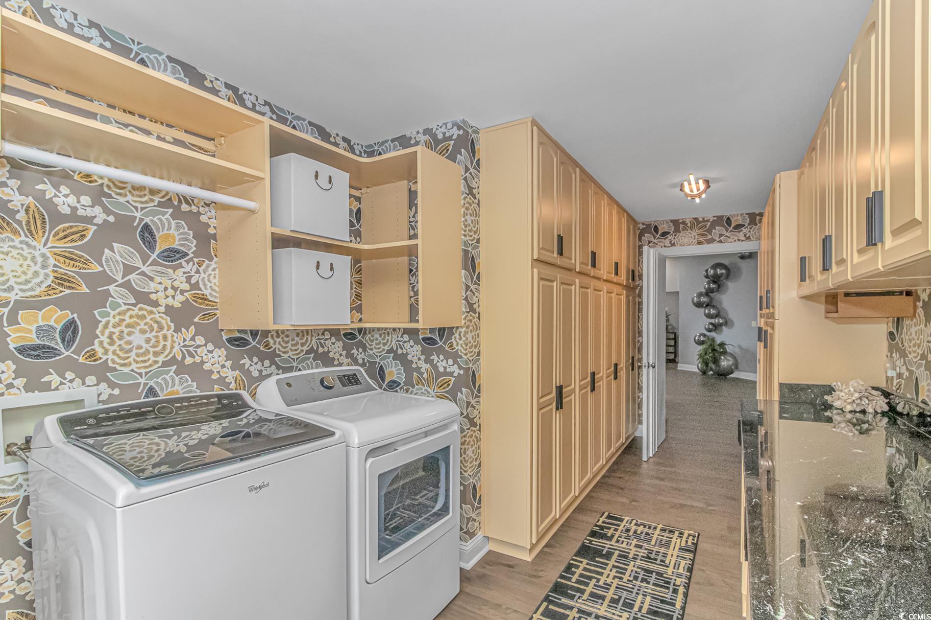 510 Rum Gully Road Murrells Inlet, SC 29576 - Photo 14 of 35 Laundry area with cabinet space, wallpapered walls, light wood-style flooring, separate washer and dryer, and baseboards