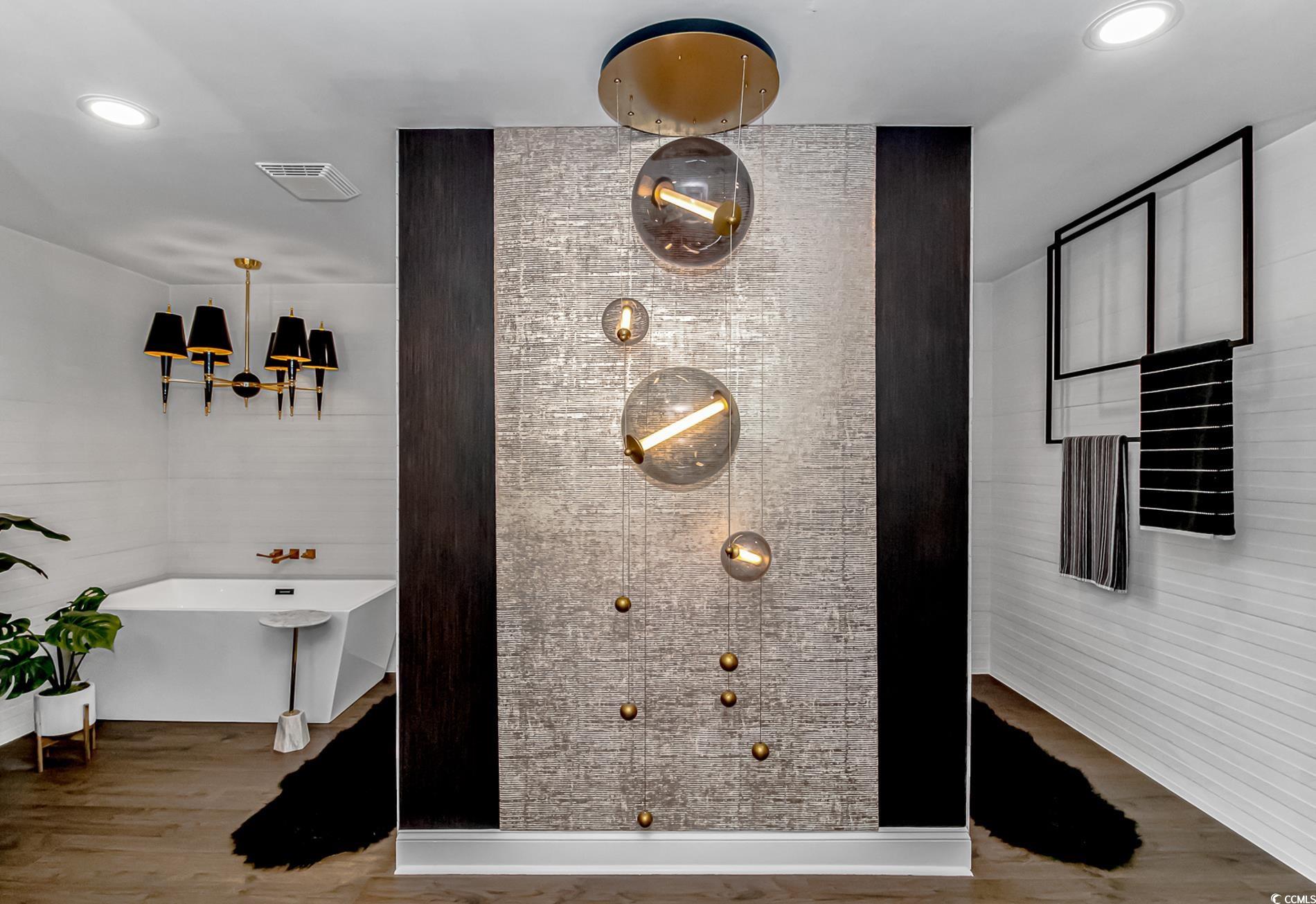 510 Rum Gully Road Murrells Inlet, SC 29576 - Photo 20 of 35 Full bathroom featuring a freestanding bath, a chandelier, wood finished floors, and tiled shower