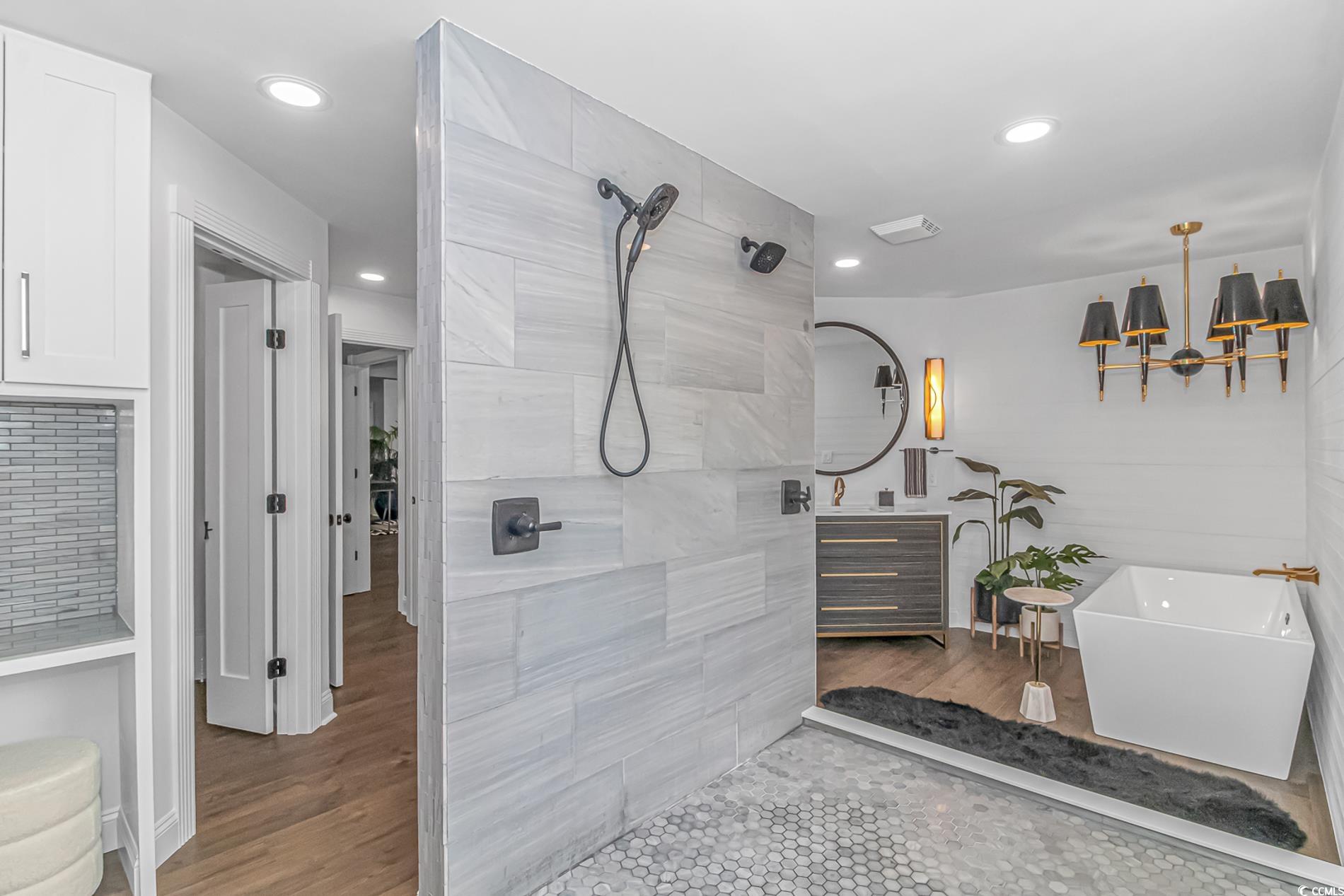 510 Rum Gully Road Murrells Inlet, SC 29576 - Photo 22 of 35 Bathroom with vanity, tiled shower, a freestanding tub, a chandelier, and wood finished floors