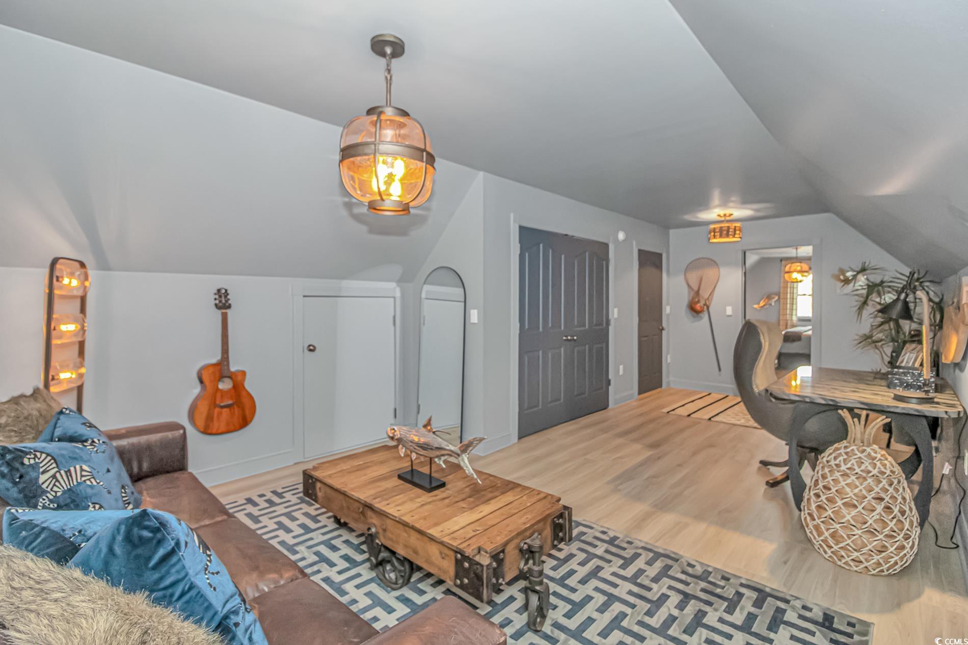 510 Rum Gully Road Murrells Inlet, SC 29576 - Photo 27 of 35 Living room featuring wood finished floors and lofted ceiling