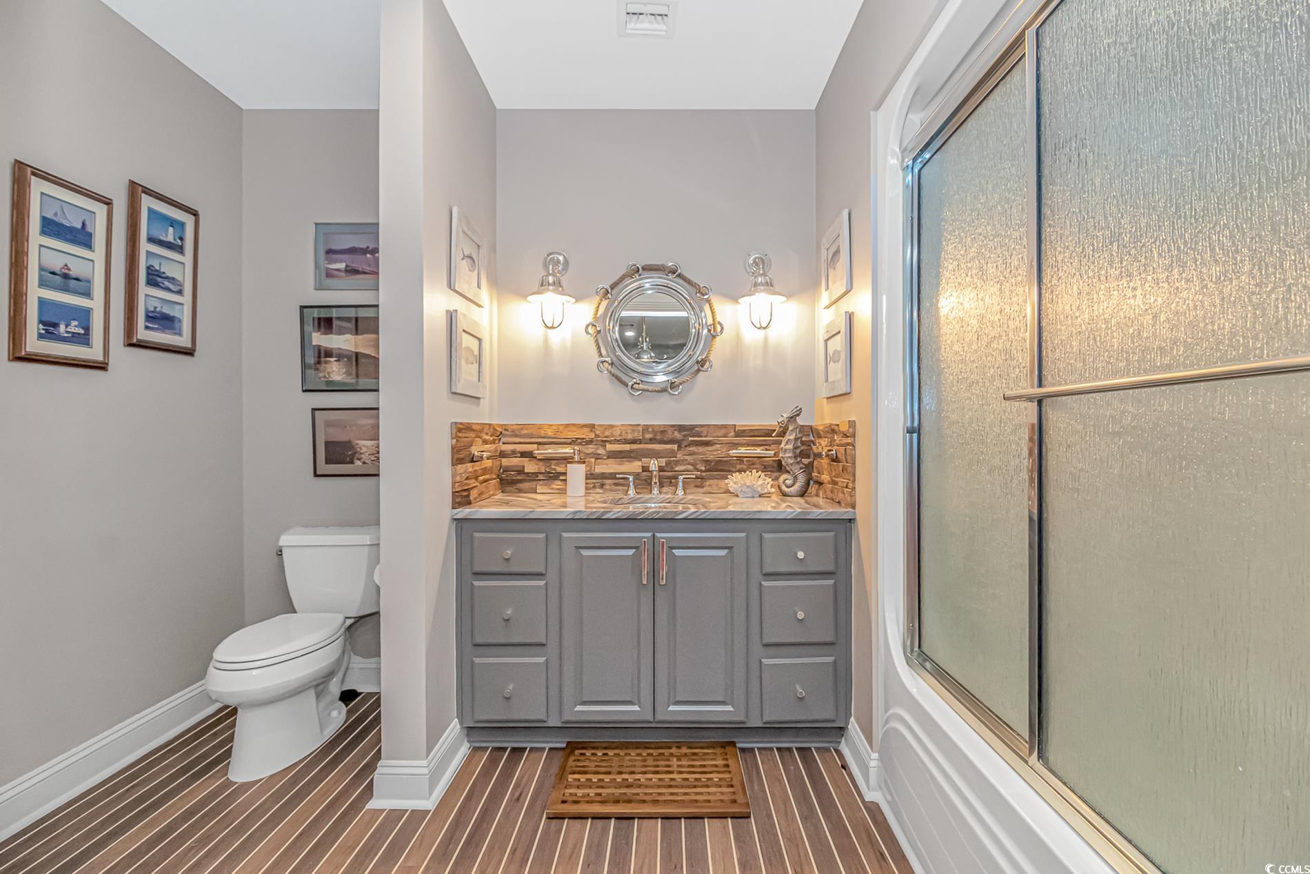 510 Rum Gully Road Murrells Inlet, SC 29576 - Photo 6 of 35 Full bathroom with toilet, vanity, and baseboards