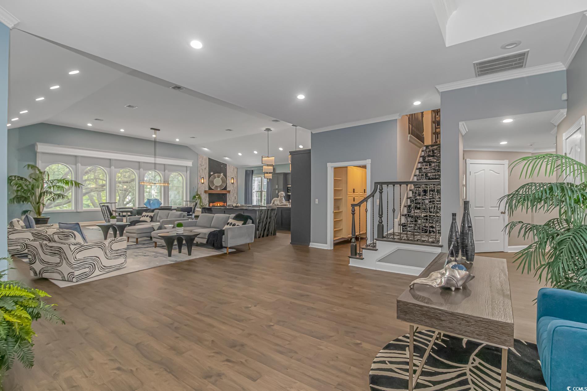 510 Rum Gully Road Murrells Inlet, SC 29576 - Photo 9 of 35 Living area with wood finished floors, stairs, crown molding, baseboards, and recessed lighting