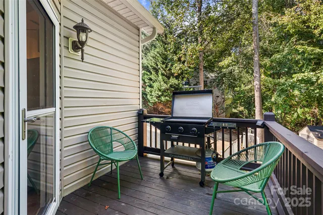 a view of a balcony with wooden floor and iron stairs