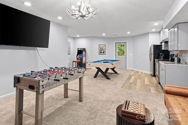 a living room with furniture stove and kitchen view