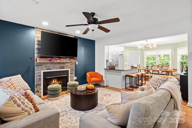 a living room with furniture a fireplace and a flat screen tv