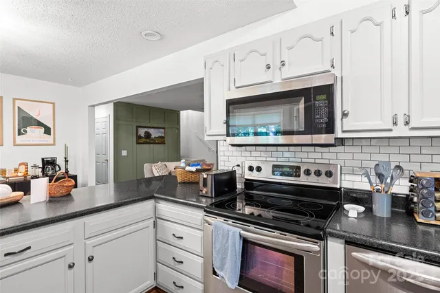 a kitchen with a stove sink and refrigerator