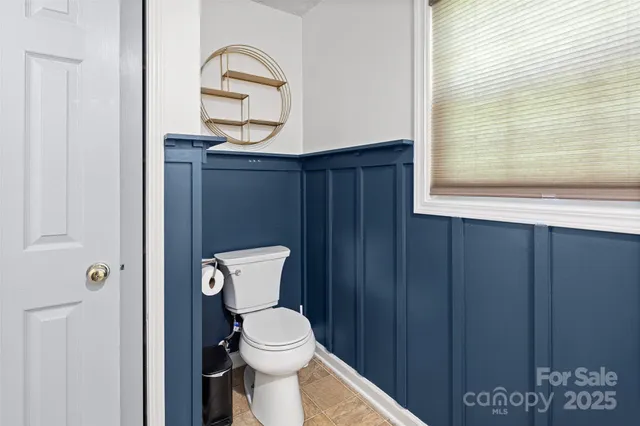 a en suite bathroom with a granite countertop double vanity sink and a mirror
