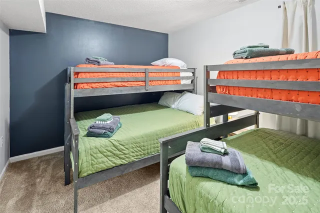 a bedroom with bed and a couch