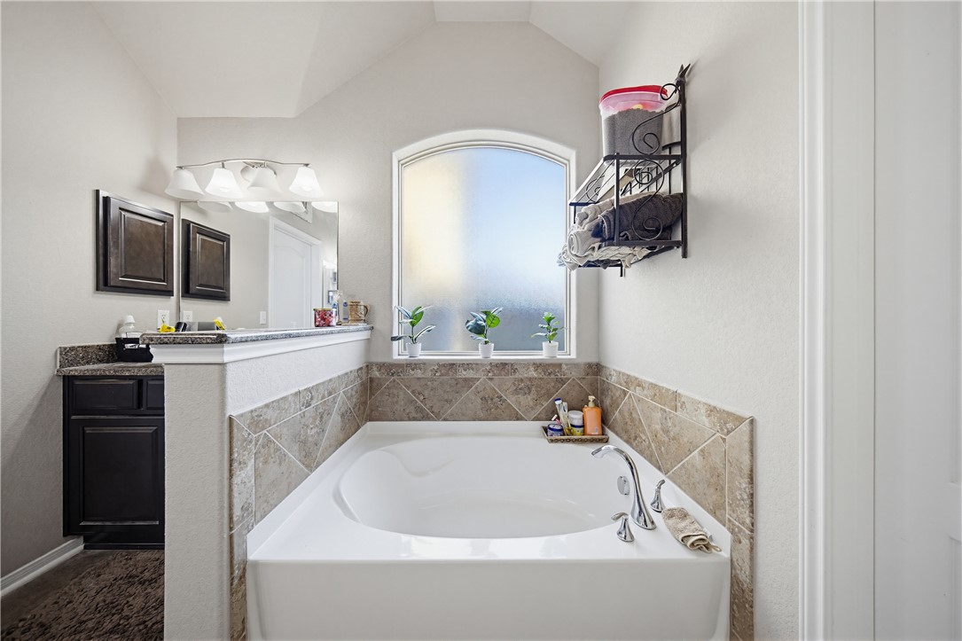 2129 Escondido Street Portland, TX 78374 - Photo 17 of 29 a bathroom with a bathtub sink and mirror