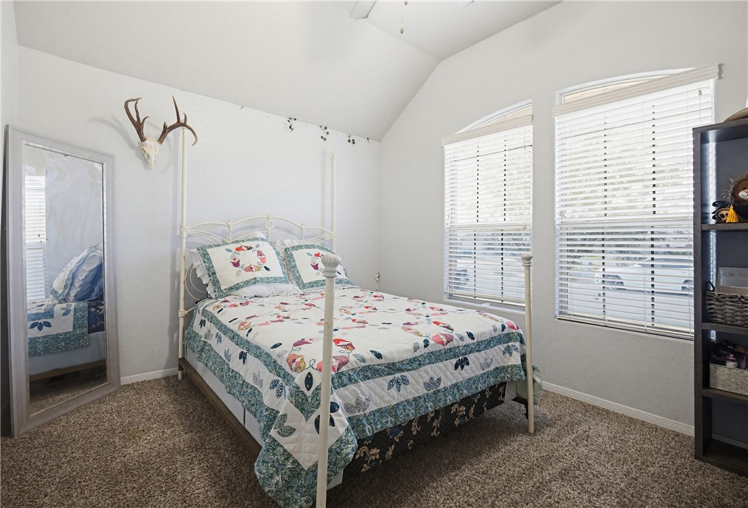 2129 Escondido Street Portland, TX 78374 - Photo 18 of 29 a bed sitting in a bedroom next to a window