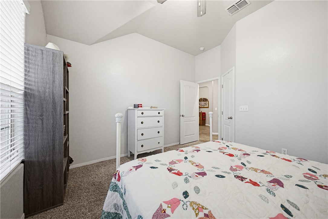 2129 Escondido Street Portland, TX 78374 - Photo 19 of 29 a bedroom with a bed and a dresser