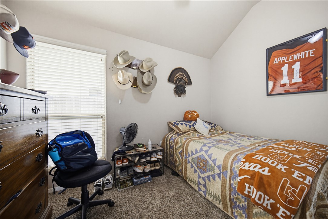 2129 Escondido Street Portland, TX 78374 - Photo 23 of 29 a bedroom with a bed and chair